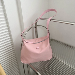 Modern pink Oxford cloth square shoulder bag displayed on a sleek metal rack