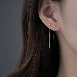 Minimalist gold ball stud earrings with long tassel threader chains for a modern look