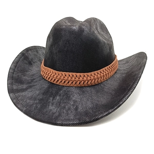 Detail of the black western cowboy hat featuring a brown braided band and vintage matte felt texture