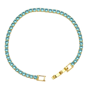 Detailed close-up of a gold-plated tennis bracelet featuring round-cut light blue cubic zirconia