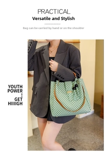 Light green printed handbag with brown leather handles and black tassel detail