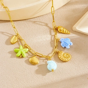 Gold ocean charms necklace with starfish shell and turtle pendants on linked chain