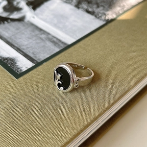 Macro shot of S925 sterling silver tulip ring with black enamel and adjustable band