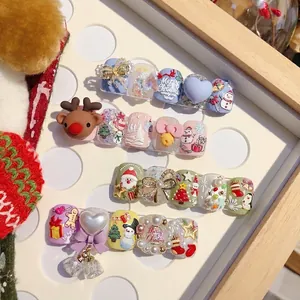 3D Christmas embossed press-on nails with reindeer and snowman designs in pastel colors