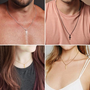 Close-up of double-layer stainless steel cross pendant necklaces in silver, gold, and black