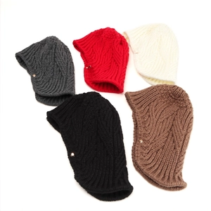 Detail of knitted earmuff caps in five colors featuring thick cable texture and metal buttons