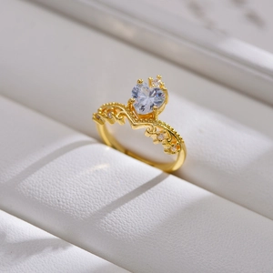 Detailed view of the gold heart ring with crown details and clear cubic zirconia stones