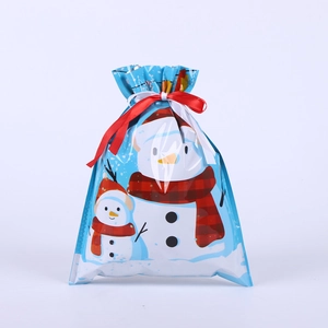 Detail of Christmas drawstring gift bag with snowman pattern and festive ribbon