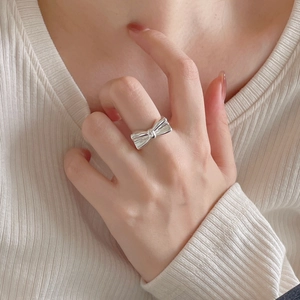 Elegant 925 sterling silver bow ring for women worn on finger with minimalist style