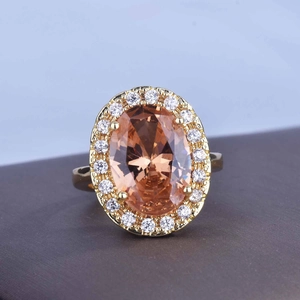 Luxury 18k gold plated halo ring featuring a large oval champagne gemstone and diamonds