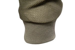 Detail of olive green jacket sleeve showing waffle texture and ribbed knit elastic cuffs