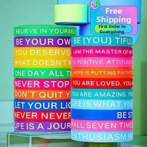 Macro shot of colorful hip hop silicone bracelets with motivational text in 20 colors