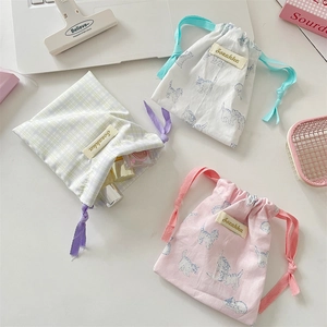 Three cute drawstring storage bags with floral and cat prints for lipsticks and small items