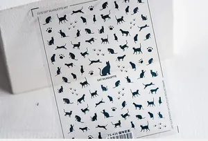 Close-up of TS-426 nail stickers featuring black cat silhouettes and paw print patterns