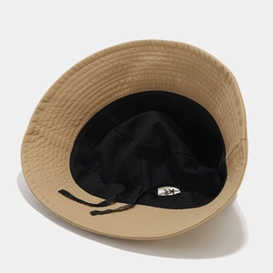 Detail of khaki bucket hat interior featuring adjustable drawstring and sweatband