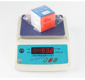 Detailed view of a 3x3 speed cube being weighed at 53.2g for precise toy specifications