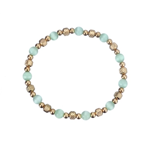 Elegant beaded bracelet with pale green cat eye stones and golden textured metal beads