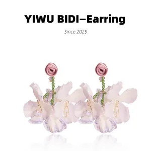 Detail of pink rose and lilac orchid flower earrings with sparkling crystal droplets