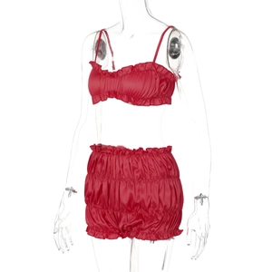 Detail of red satin two-piece set featuring ruffled camisole top and high-waist shorts