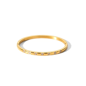 Detailed close-up of a 18k gold-plated bangle set with sparkling white cubic zirconia stones