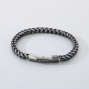 Close-up of vintage steel chain bracelet featuring a secure industrial plug-in clasp