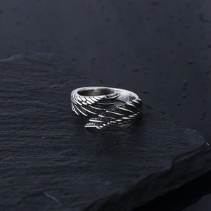 Vintage 925 sterling silver angel wing feather open ring for men on dark stone texture