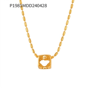 Detail of gold-plated titanium necklace with hollow cube pendant and oval bead chain