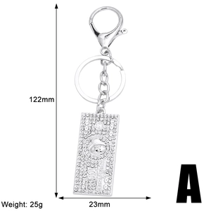 Detailed size view of silver dollar sign keychain with white rhinestones and measurements