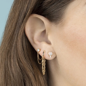 Elegant gold S925 earrings set with tassels and heart opal stones on model ear