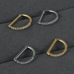 Titanium D-shaped clicker jewelry set with sparkling cubic zirconia in gold and silver