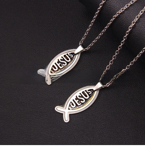 Macro detail of stainless steel Jesus fish pendant necklace with cutout design
