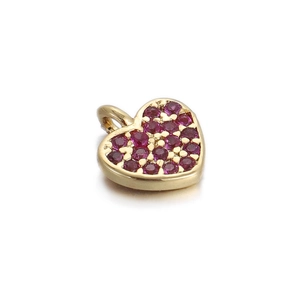 Close-up of a 14k gold heart charm with pavé pink ruby-colored crystals on white background
