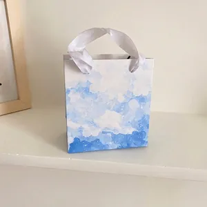 Dreamy blue and white watercolor cloud gift bag with soft white satin handles