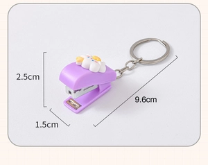 Mini purple stapler keychain with cloud figure showing dimensions of 9.6cm total length