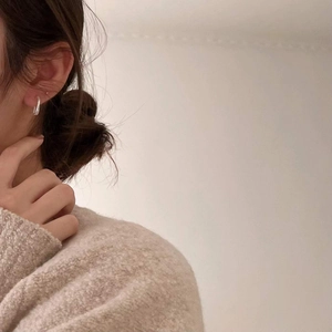 Minimalist 925 sterling silver hoop earrings with wave texture on model
