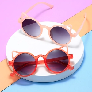 Stylish cat-ear children's sunglasses in pink and red with round UV protection frames