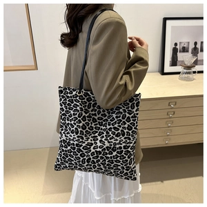 Leopard print canvas tote bag styled on model for casual commuting and daily fashion