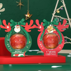 Christmas apple gift boxes in red and green with festive reindeer antlers and ribbons