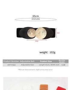 Detail of 6cm wide black elastic waist belt featuring a 13cm gold metal sunburst buckle