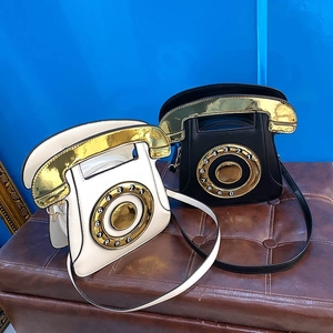 Detail of vintage telephone bags in black and white with gold receiver handles