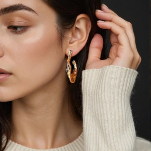 Polished 18k gold plated stainless steel twisted geometric earrings on model
