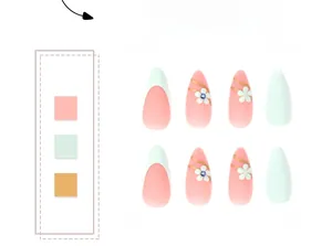 Detail of green and pink press-on nails with white floral patterns and gold accents