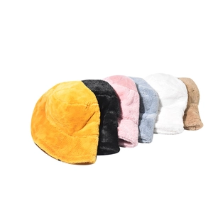 Detailed view of plush bucket hats in yellow, black, pink, blue, white, and khaki colors