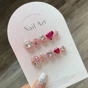 Sparkly raspberry pink press-on nails with 3D heart rhinestones and glitter finish