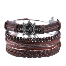 Detail of multi-layer leather bracelets with wooden beads and metal anchor charm