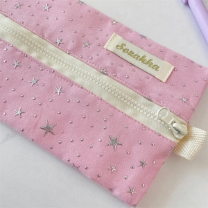 Detail of pink star-pattern canvas pencil case with high-quality white plastic zipper