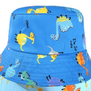 Close-up of baby sun hat with colorful dinosaur prints and 'COOL' embroidery