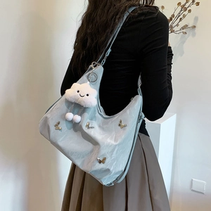 Chic light blue pleated crescent shoulder bag with butterfly studs and cloud charm