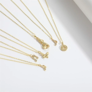 Golden fashion necklace with musical note and starburst pendants on fine cross chain