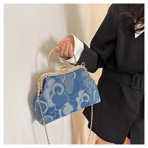 Detail of denim clutch bag with auspicious cloud jacquard and rhinestone metal frame